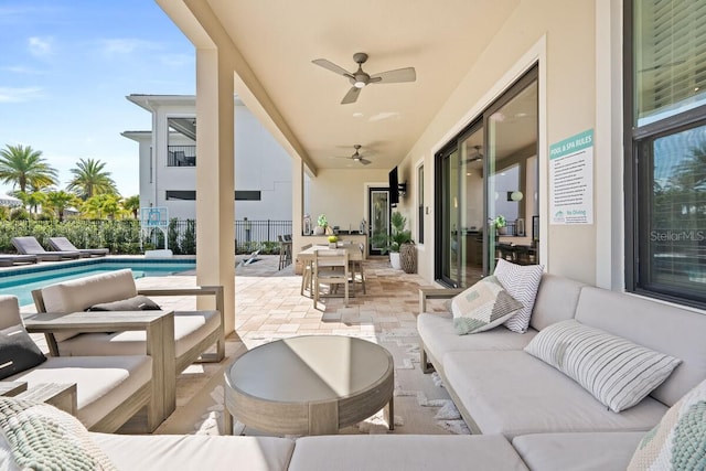 view of terrace featuring a fenced in pool, an outdoor living space, and ceiling fan