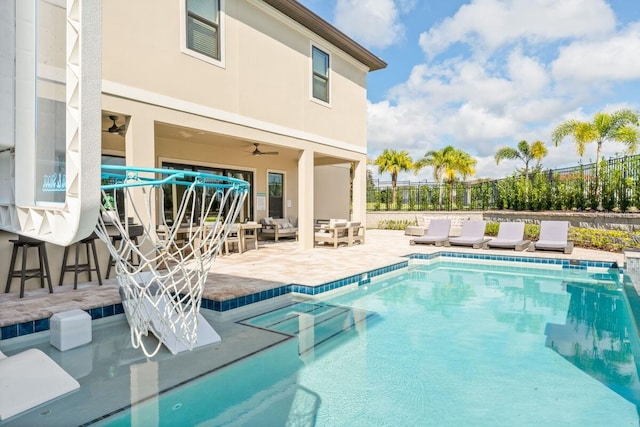 view of pool with ceiling fan and a patio