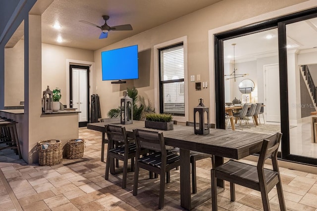 interior space with light tile floors and ceiling fan with notable chandelier