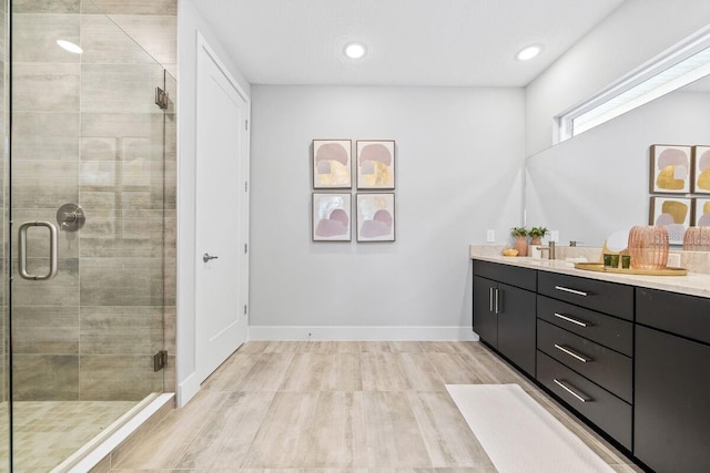 bathroom with vanity and a shower with door