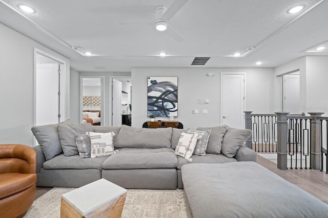 living room featuring ceiling fan and light hardwood / wood-style flooring