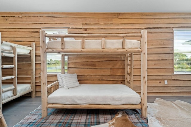 bedroom featuring multiple windows and dark wood-type flooring