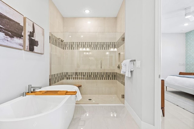 bathroom featuring shower with separate bathtub and tile flooring