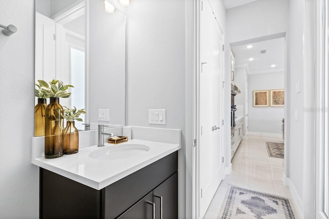 bathroom with ornamental molding, large vanity, and tile flooring