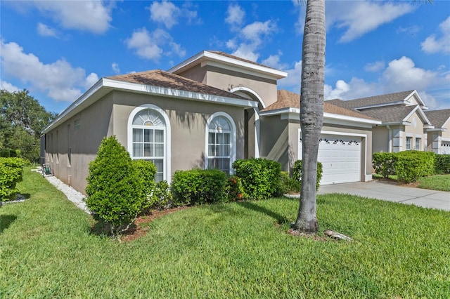 view of front of house with a front yard and a garage