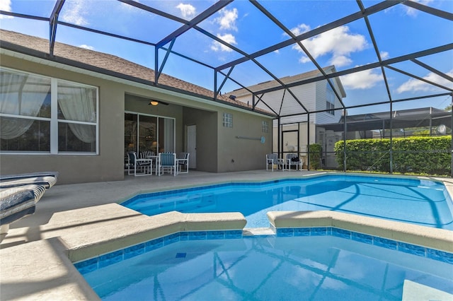 view of pool featuring a lanai, ceiling fan, and a patio