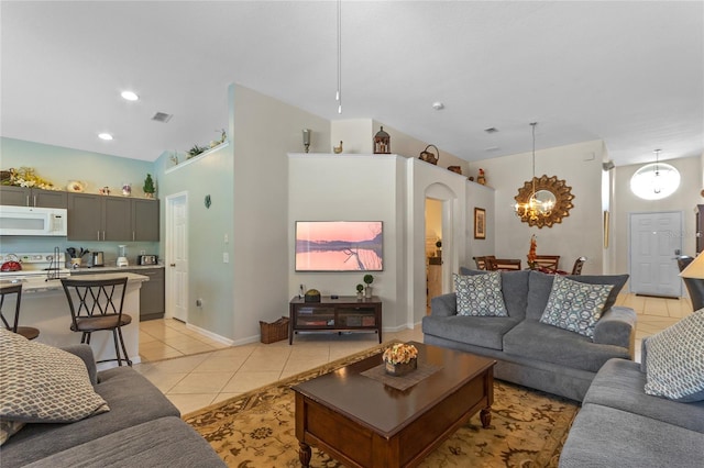 tiled living room with a chandelier