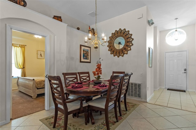 dining space with a notable chandelier and light tile floors