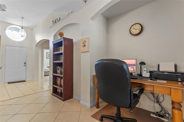 tiled home office with a notable chandelier