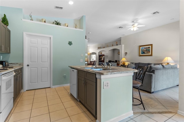 kitchen featuring ceiling fan, white appliances, a breakfast bar, light tile floors, and gray cabinets