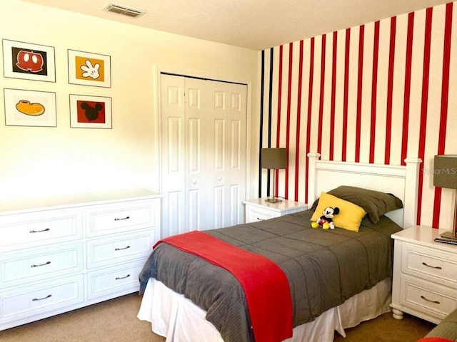 bedroom with light carpet and a closet