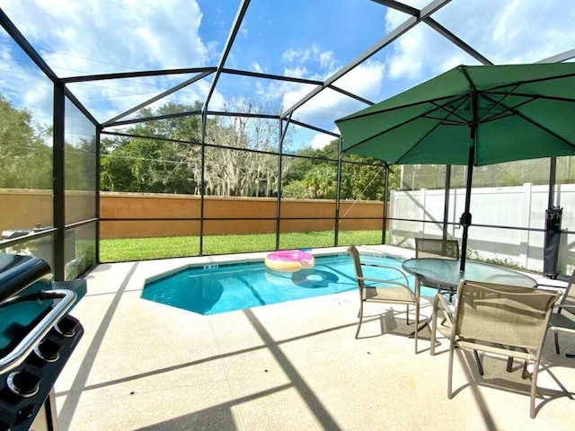 view of swimming pool with a patio area and glass enclosure