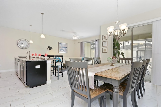 tiled dining area with sink and ceiling fan with notable chandelier