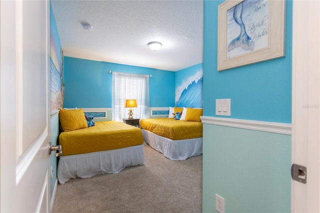 bedroom featuring carpet floors and a textured ceiling