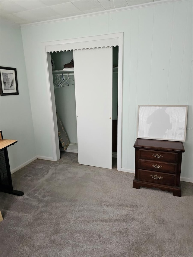 unfurnished bedroom with a closet and light colored carpet