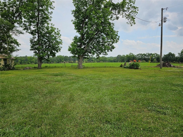 view of yard with a rural view