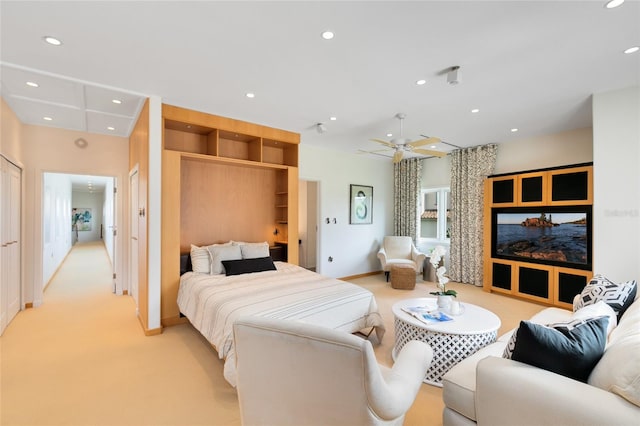 bedroom with ceiling fan, light carpet, and a closet