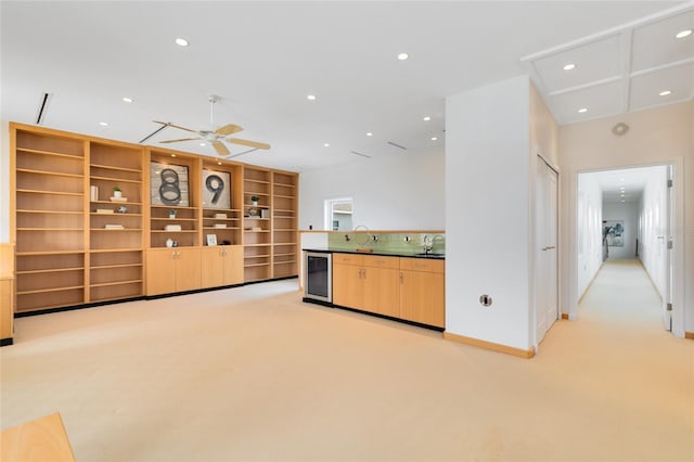 interior space featuring light colored carpet, wine cooler, ceiling fan, and sink