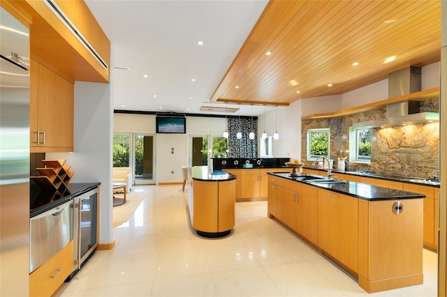 kitchen featuring decorative light fixtures, a kitchen island with sink, wooden ceiling, and sink