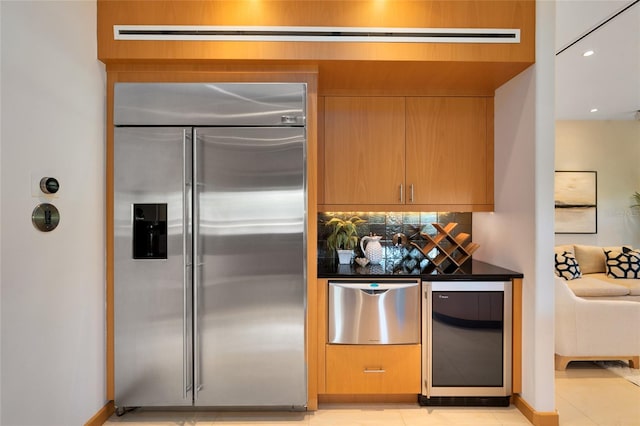 kitchen with light tile patterned floors, wine cooler, and built in refrigerator