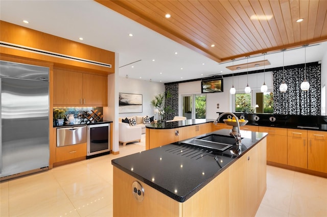 kitchen with sink, hanging light fixtures, wooden ceiling, a spacious island, and stainless steel built in fridge