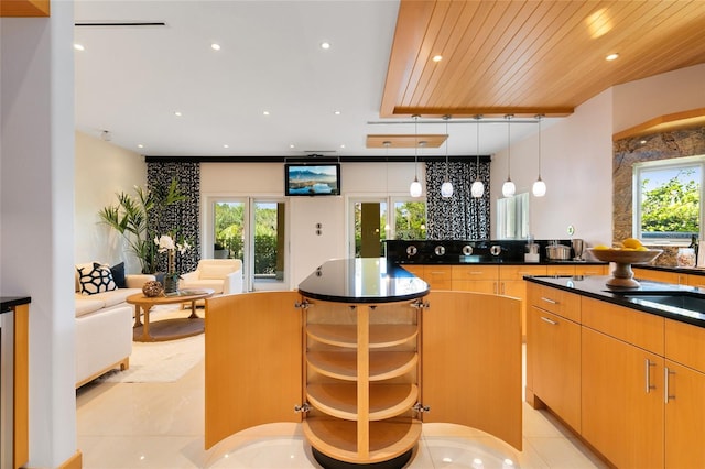 kitchen with light brown cabinets, sink, decorative light fixtures, light tile patterned floors, and wood ceiling