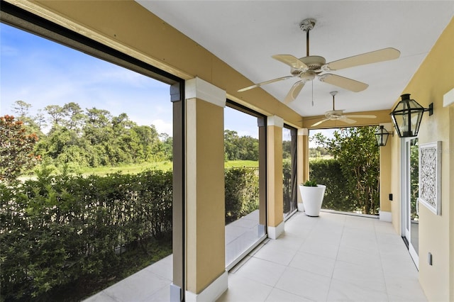 sunroom / solarium featuring ceiling fan