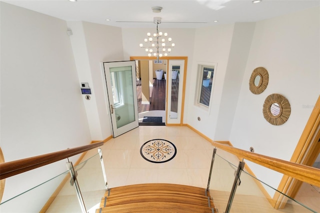 hall featuring light tile patterned floors and an inviting chandelier