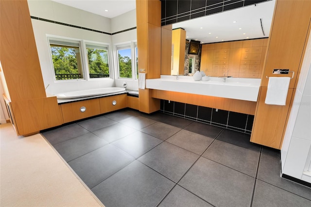 bathroom with tile patterned floors and a bathtub