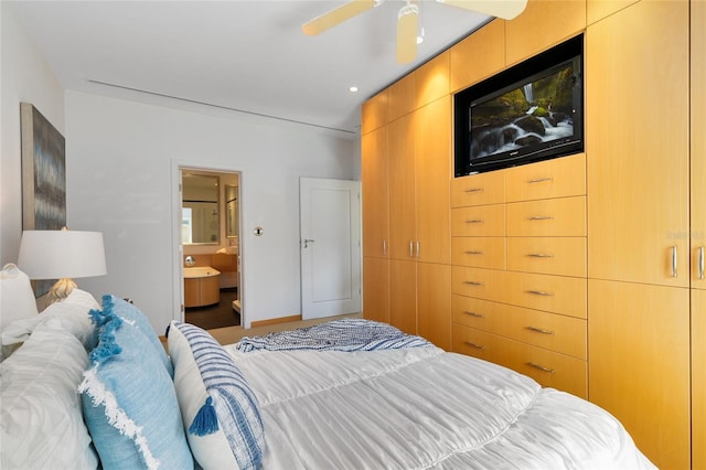 bedroom with ensuite bath and ceiling fan