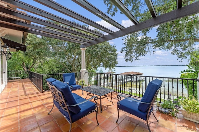 view of patio / terrace with a water view and a pergola