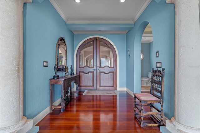 entrance foyer featuring dark wood-type flooring and ornamental molding