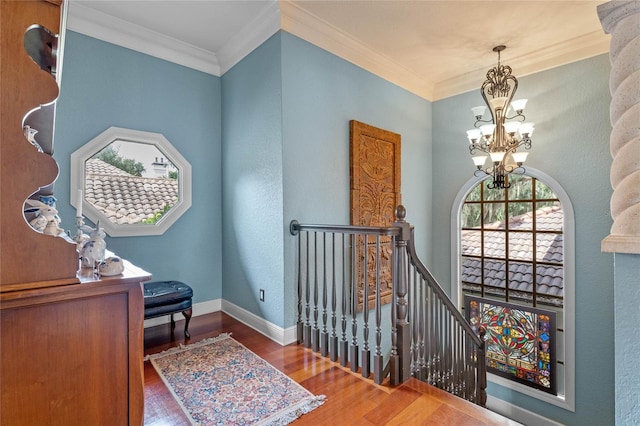 interior space featuring crown molding, dark hardwood / wood-style flooring, and a chandelier