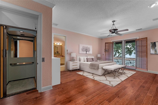 bedroom with wood-type flooring, ornamental molding, access to exterior, and a textured ceiling