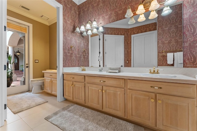 bathroom featuring crown molding, vanity, tile patterned floors, and toilet