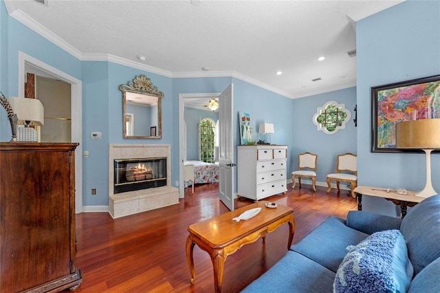 living room with ornamental molding, a premium fireplace, and dark hardwood / wood-style flooring