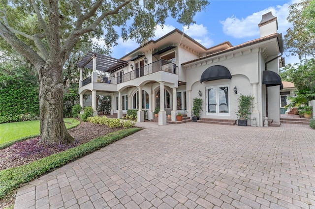 back of house with a balcony and french doors