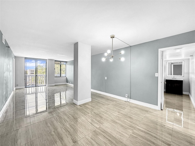 interior space with baseboards and a notable chandelier