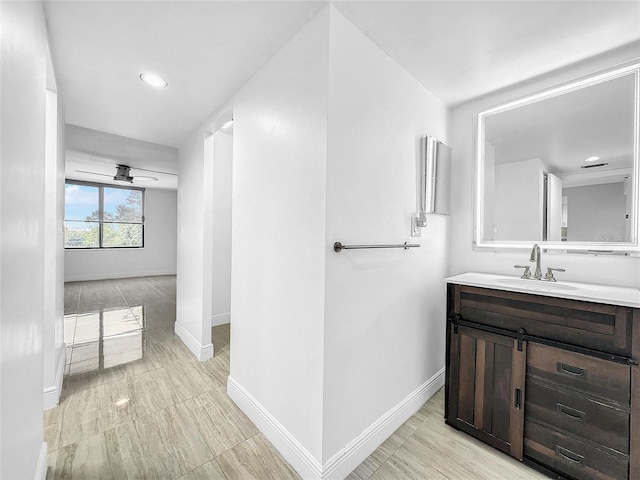 bathroom with vanity, baseboards, and ceiling fan