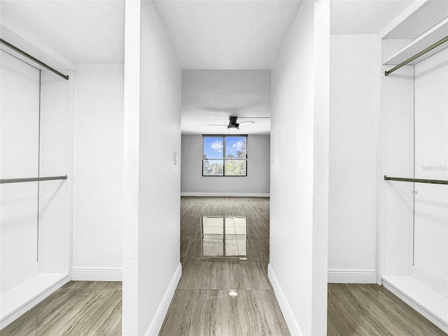 spacious closet with a ceiling fan and wood finished floors