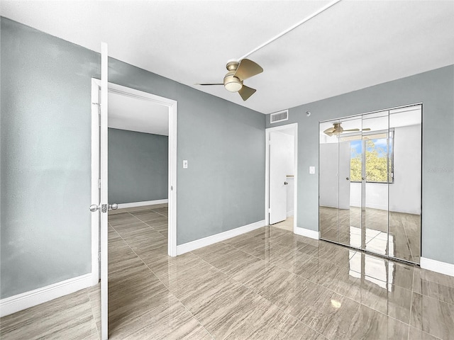 unfurnished bedroom featuring baseboards, visible vents, and ceiling fan