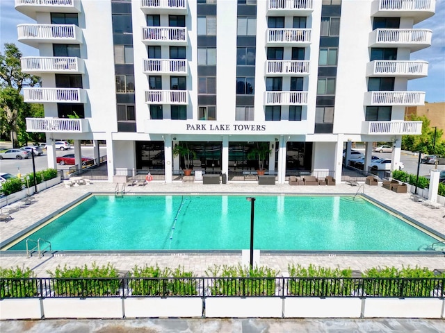 view of swimming pool featuring fence