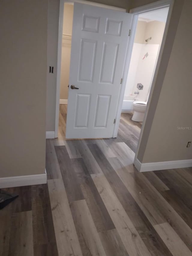 corridor featuring hardwood / wood-style floors