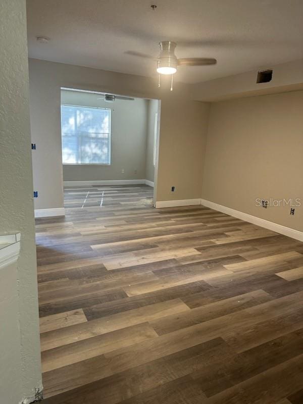 empty room featuring hardwood / wood-style flooring and ceiling fan