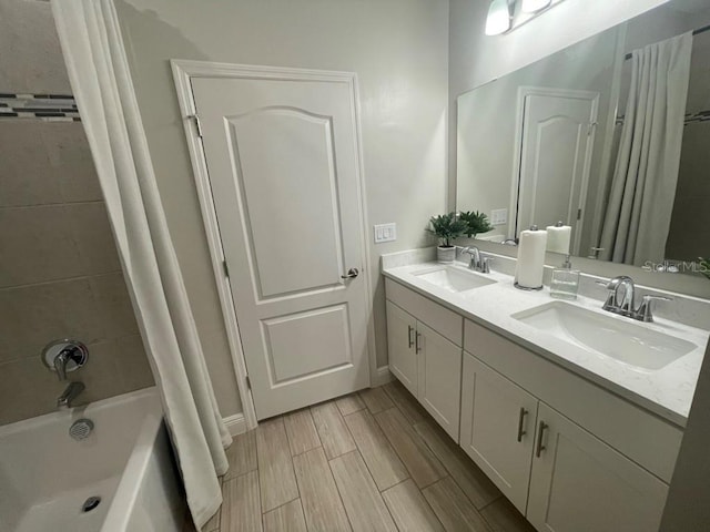 bathroom featuring shower / tub combo and vanity