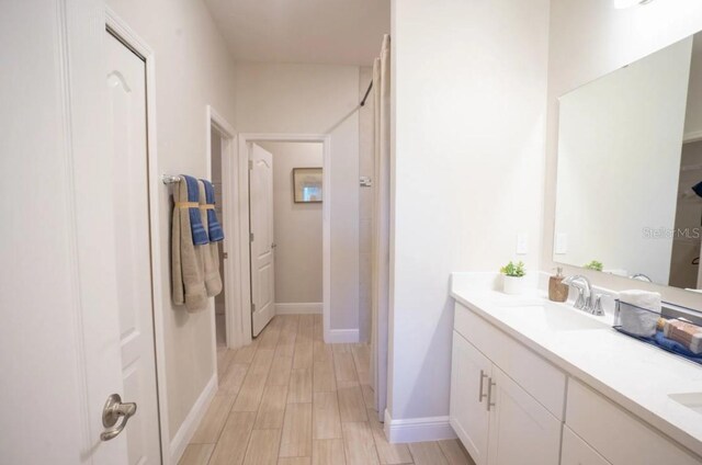 bathroom featuring vanity and hardwood / wood-style floors