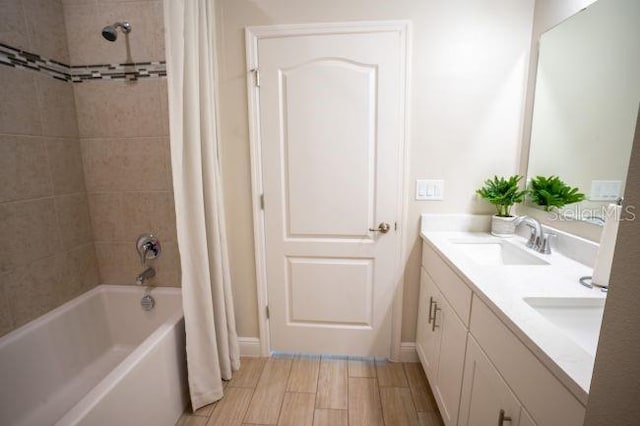 bathroom with shower / tub combo with curtain and vanity