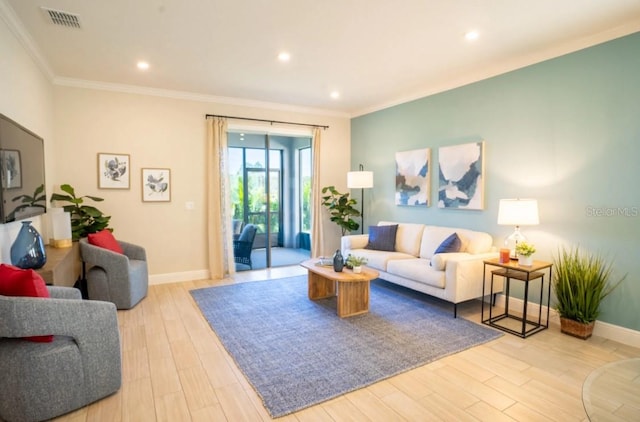 living room with ornamental molding and light hardwood / wood-style floors