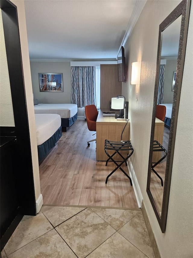 bedroom with crown molding and light hardwood / wood-style flooring