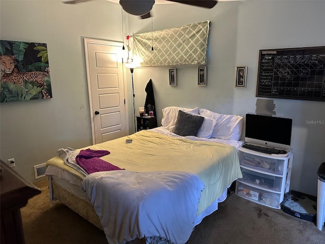 bedroom with ceiling fan and dark colored carpet